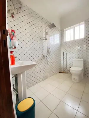 a bathroom with a shower and a toilet in it at SandS Escape in Arusha