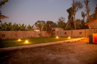 a backyard with lights on the grass at night at Shavia Lodge in Arusha