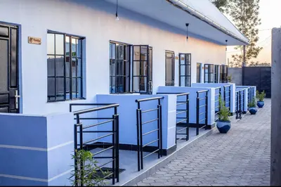 a white building with a row of windows at Shavia Lodge in Arusha