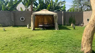a gazebo with a table and chairs in a yard at Shavia Lodge in Arusha