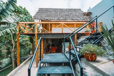 a house with a staircase leading up to it at Samora River Lodge in Kioga