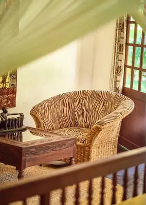 a zebra print couch in a living room with a table at House of West Kili in Bondeni Boloti
