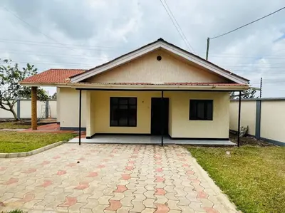 a small house with a driveway in front of it at Mlay Home in Arusha