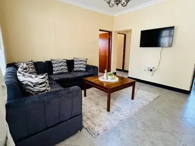a living room with a couch and a coffee table at Mlay Home in Arusha