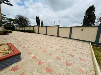 a brick patio with stars on it next to a fence at Mlay Home in Arusha