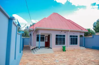 a small pink house with a red roof at Mati Residence Ngarenaro in Babati
