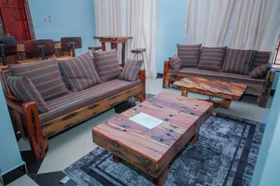 a living room with couches and a coffee table at Mati Residence Ngarenaro in Babati