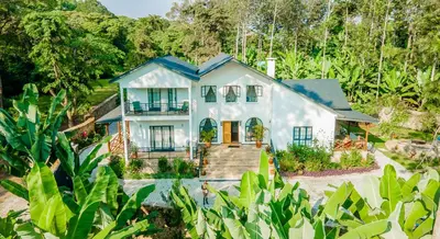 an aerial view of a white house with trees at Treetops Villa in Arusha