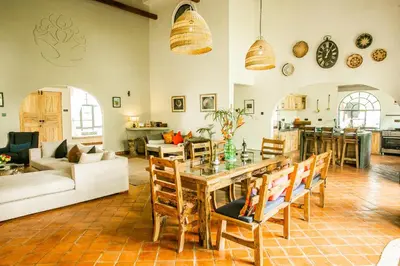 a large living room with a table and chairs at Treetops Villa in Arusha