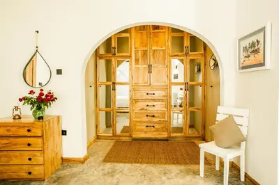 a room with a wooden door and a wooden dresser at Treetops Villa in Arusha