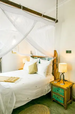 a bedroom with a bed with a canopy at Treetops Villa in Arusha