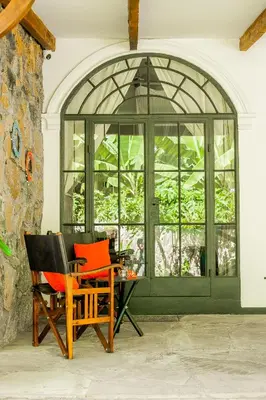 two chairs and a table in front of a window at Treetops Villa in Arusha