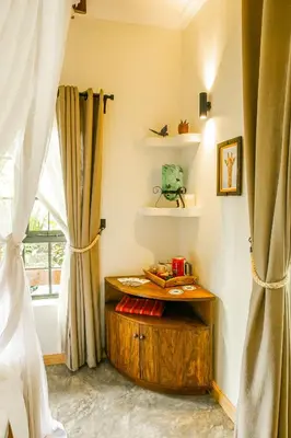 a room with a wooden table and a window at Treetops Villa in Arusha