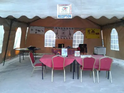 a tent with a pink table and chairs in it at Fanaka Safaris Campsite & Lodges in Mto wa Mbu