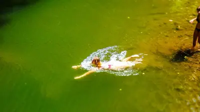a person swimming in a body of water at Makini Swing Adventure in Arusha