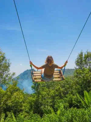 a person on a zip line in the jungle at Makini Swing Adventure in Arusha