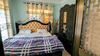 a bedroom with a bed with a checkered blanket at 3 Bedroom Appartment with Beautiful view of Kilimanjaro Mountain in Moshi