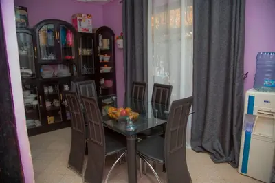 a dining room with a glass table and chairs at 3 Bedroom Appartment with Beautiful view of Kilimanjaro Mountain in Moshi