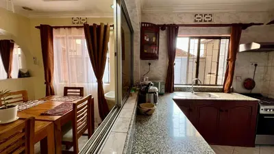 a kitchen with a sink and a counter top at Ultra Home Apartment in Themi