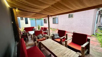 a group of chairs and tables on a patio at Ultra Home Apartment in Themi