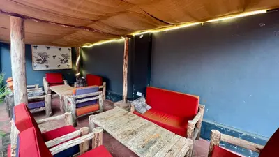 a room with chairs and a table and red chairs at Ultra Home Apartment in Themi