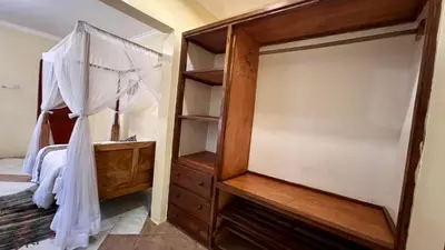a bedroom with a canopy bed and a dresser at Ultra Home - Bed and Breakfast in Themi