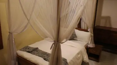 a bedroom with a canopy bed with white curtains at Ultra Home - Bed and Breakfast in Themi