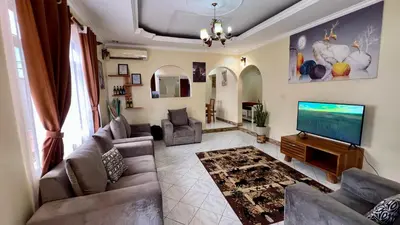a living room with couches and a flat screen tv at Ultra Home - Bed and Breakfast in Themi