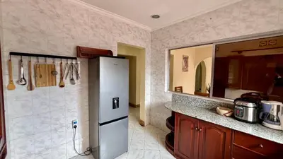 a kitchen with a refrigerator and a counter with a mirror at Ultra Home - Bed and Breakfast in Themi