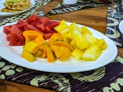 a white plate of fruit on a table at Ultra Home - Bed and Breakfast in Themi