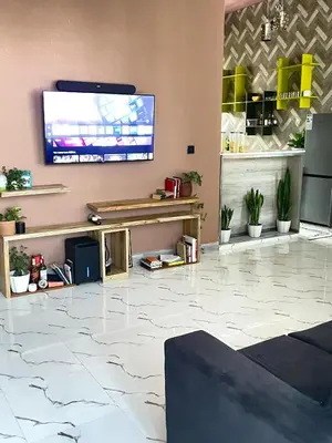 a lobby with a flat screen tv on a wall at Stay with Rodjazz in Usa River
