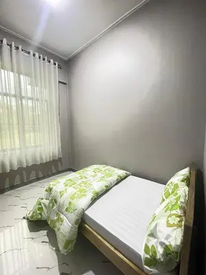 a bedroom with a bed and a window at Stay with Rodjazz in Usa River