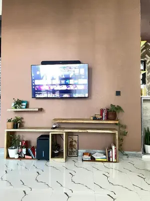 a flat screen tv hanging on a wall above a table at Stay with Rodjazz in Usa River