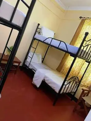 a bedroom with two bunk beds and a window at Urafiki House in Arusha