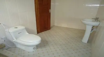 a bathroom with a toilet and a sink at Urafiki House in Arusha