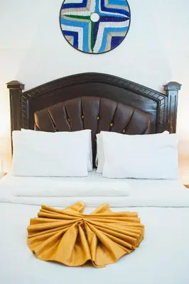 a bed with a yellow bow on top of it at SAS Residence in Arusha