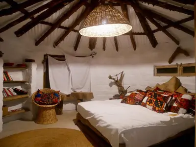 a bedroom with a bed and a chandelier at Hillside Retreat – Africa Amini Life in Usa River