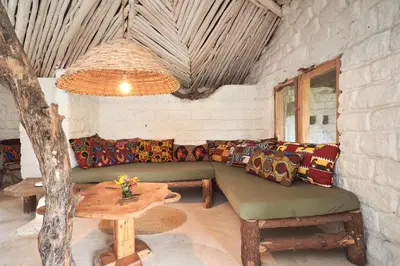 a living room with a couch and a table at Hillside Retreat – Africa Amini Life in Usa River