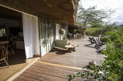 a porch of a house with a wooden deck at Hillside Retreat – Africa Amini Life in Usa River
