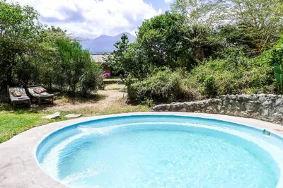 a large pool of water in a yard at Hillside Retreat – Africa Amini Life in Usa River