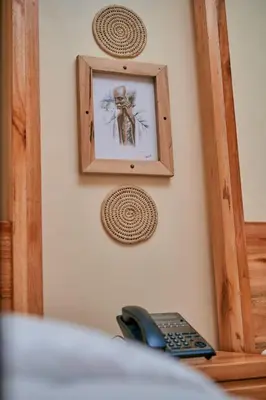 a picture of a skeleton on a wall with a telephone at Orlando Cottages in Arusha