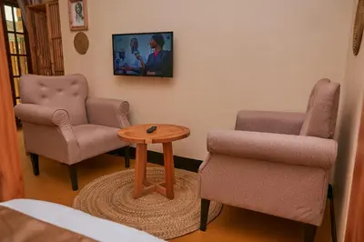 a waiting room with two chairs and a table at Orlando Cottages in Arusha