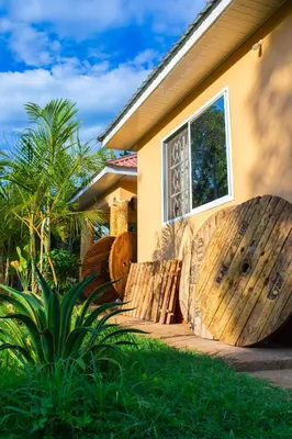 a wooden fence in front of a house at Msamaria Lori Hostel in Moshi