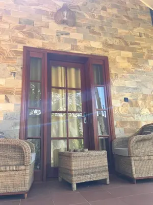 a house with two doors and two wicker chairs at Kili Touch Apts in Arusha