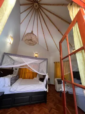 a bedroom with a bed with a canopy at Kili Touch Apts in Arusha