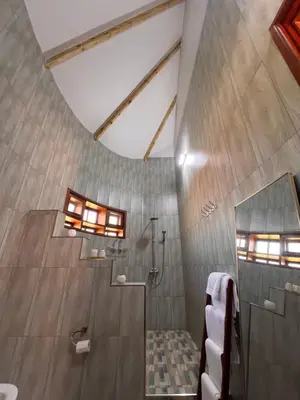 a bathroom with a shower with a glass door at Kili Touch Apts in Arusha