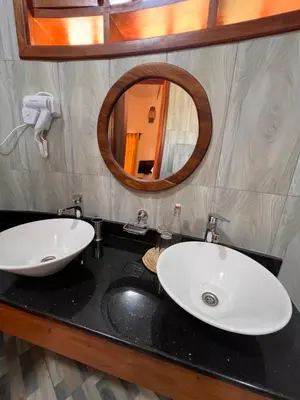 a bathroom with two sinks and a mirror at Kili Touch Apts in Arusha