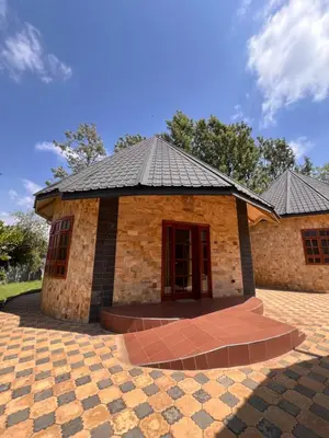a brick building with a black roof at Kili Touch Apts in Arusha