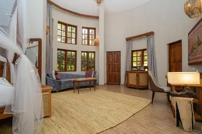 a living room with a couch and a table at Turaco Ngorongoro Valley, a Tribute Portfolio Lodge in Karatu