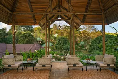 a wooden gazebo with chairs and a table at Turaco Ngorongoro Valley, a Tribute Portfolio Lodge in Karatu